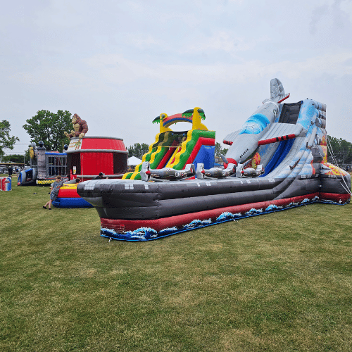 5 Different inflatable rentals at an event in a field