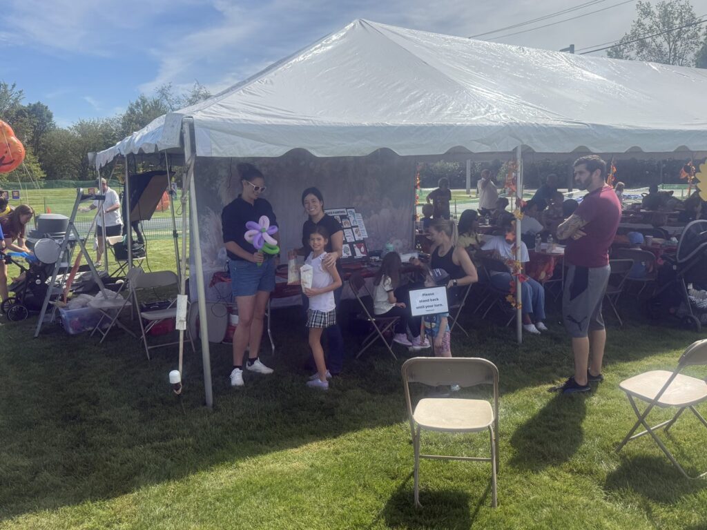 Guests gathered under a backyard party tent