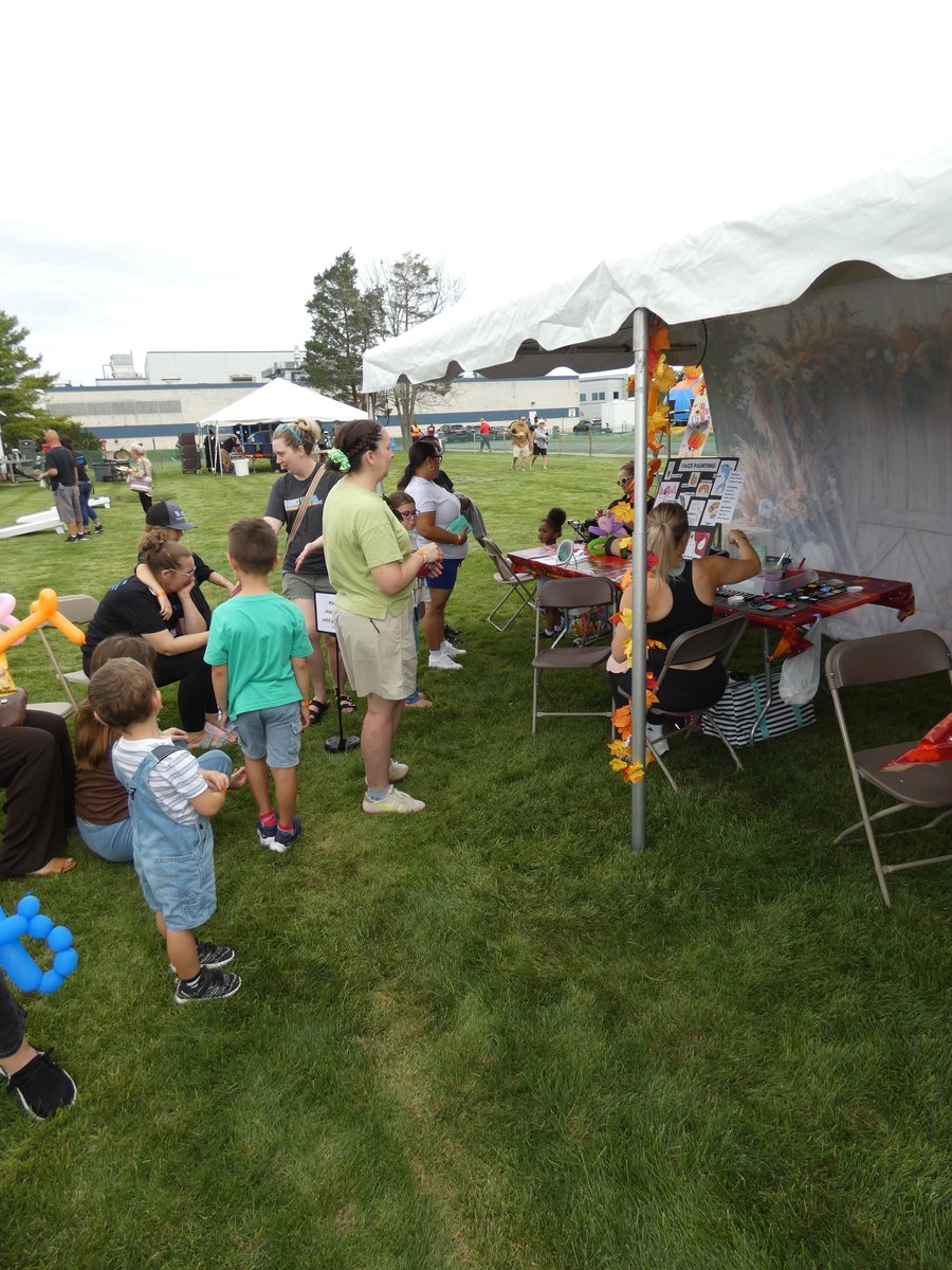 Party tent with fall leaf garland and orange tablecloth