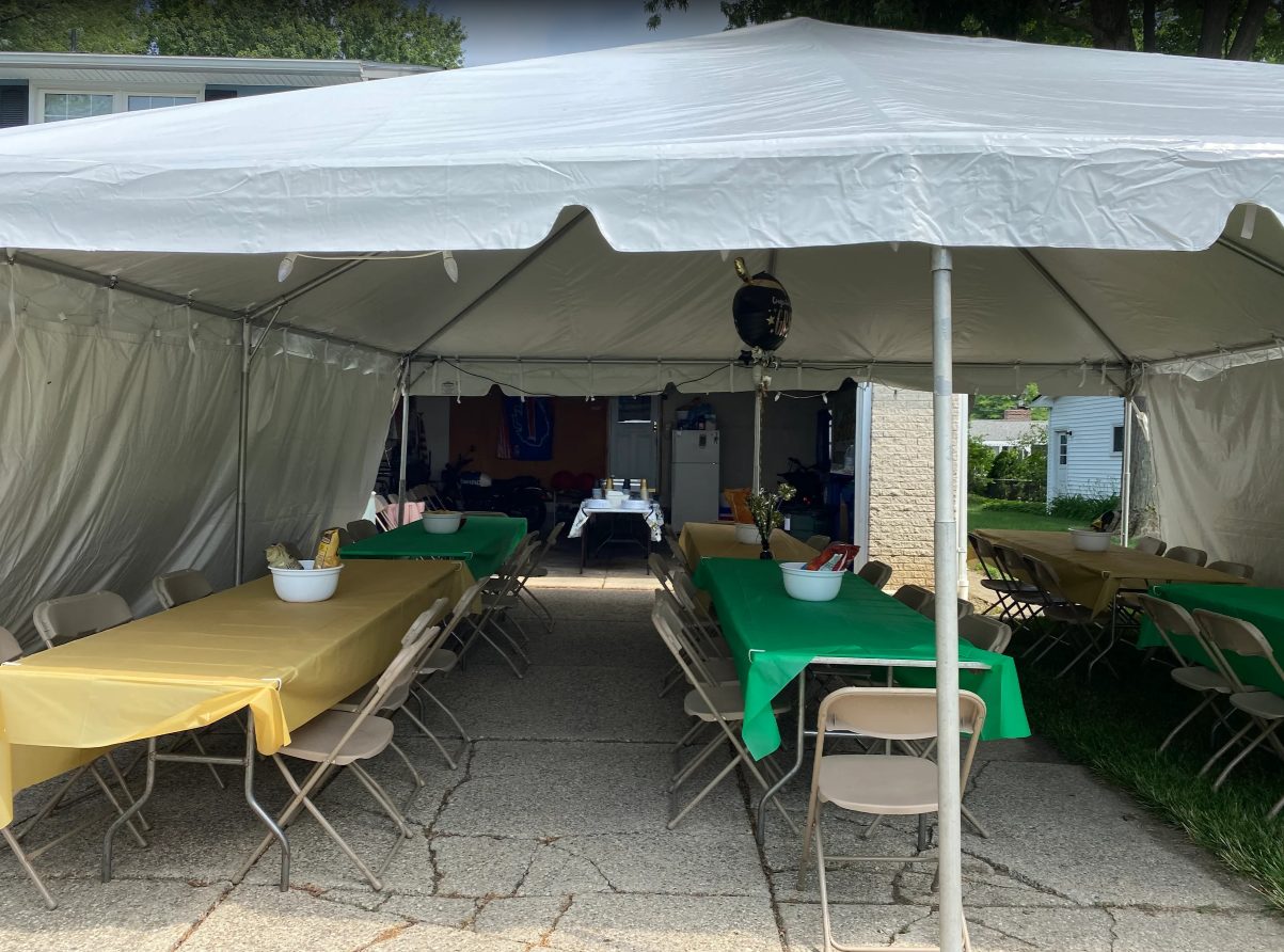 Shaded tent seating setup for a backyard birthday