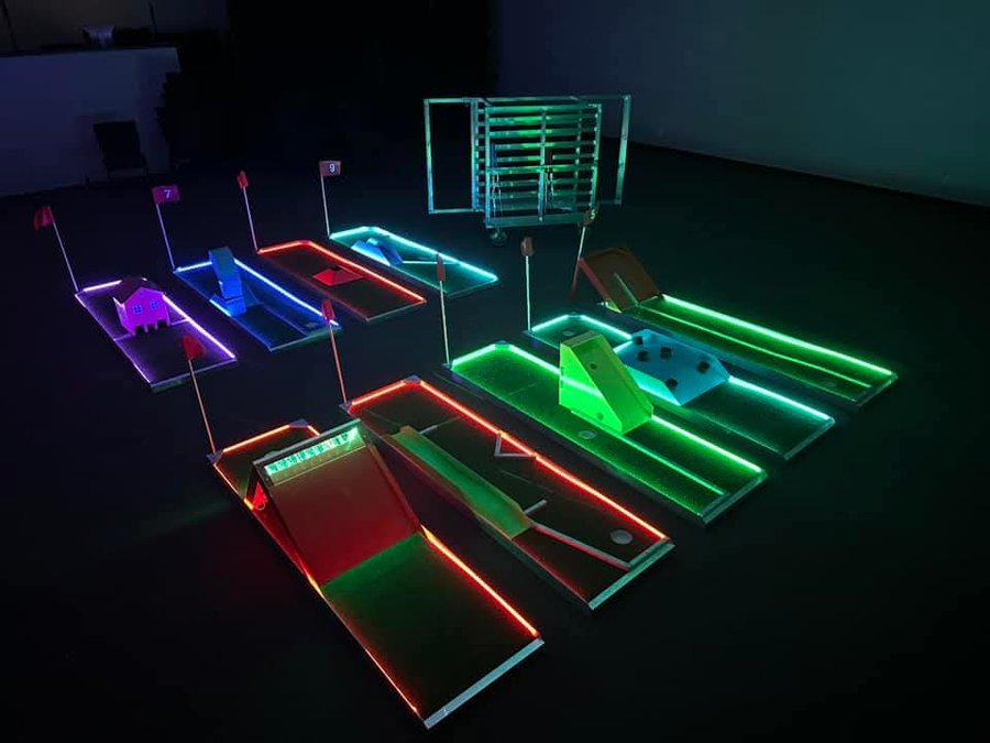 Glow mini golf course lit up in the dark