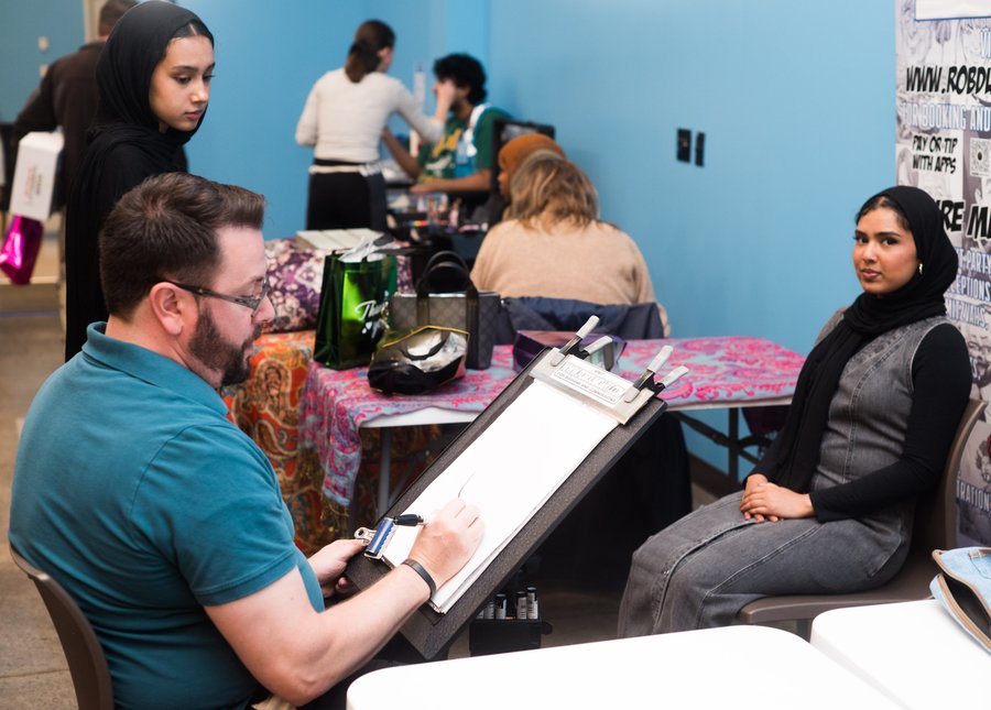 Caricature artist sketching a party guest