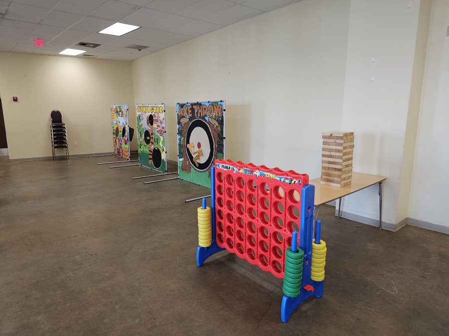 Giant Connect 4 and Giant Jenga set up indoors for a family Christmas party, Just In Case Party Rentals